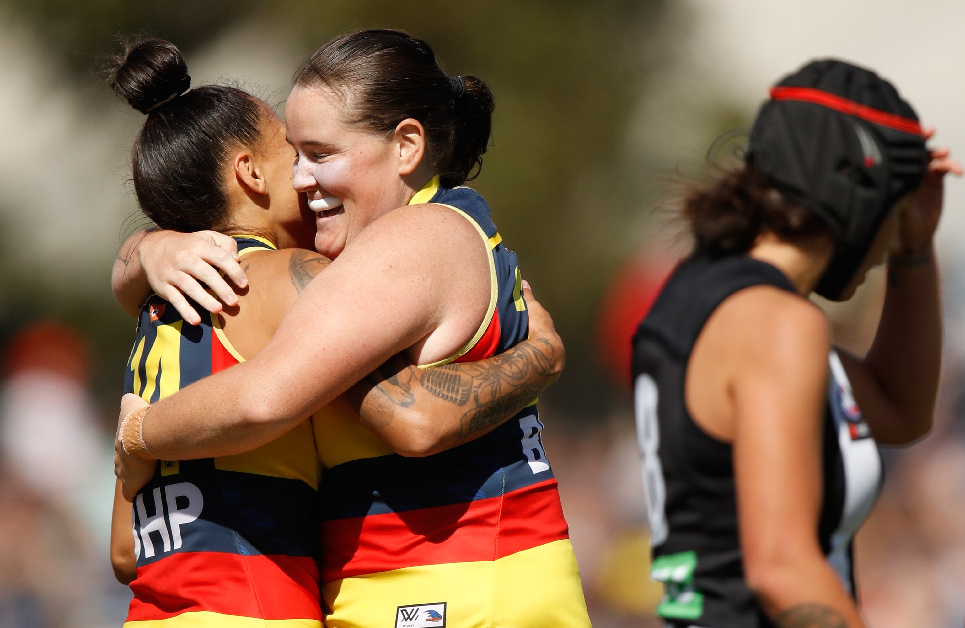 AFLW 2018 Rd 07 - Collingwood v Adelaide MELBOURNE, AUSTRALIA - MARCH 18: Stevie-Lee Thompson (left) and Sarah Perkins of the Crows celebrate during the 2018 AFLW Round 07 match between the Collingwood Magpies and the Adelaide Crows at Olympic Park Oval on March 18, 2018 in Melbourne, Australia. (Photo by Michael Willson/AFL Media)